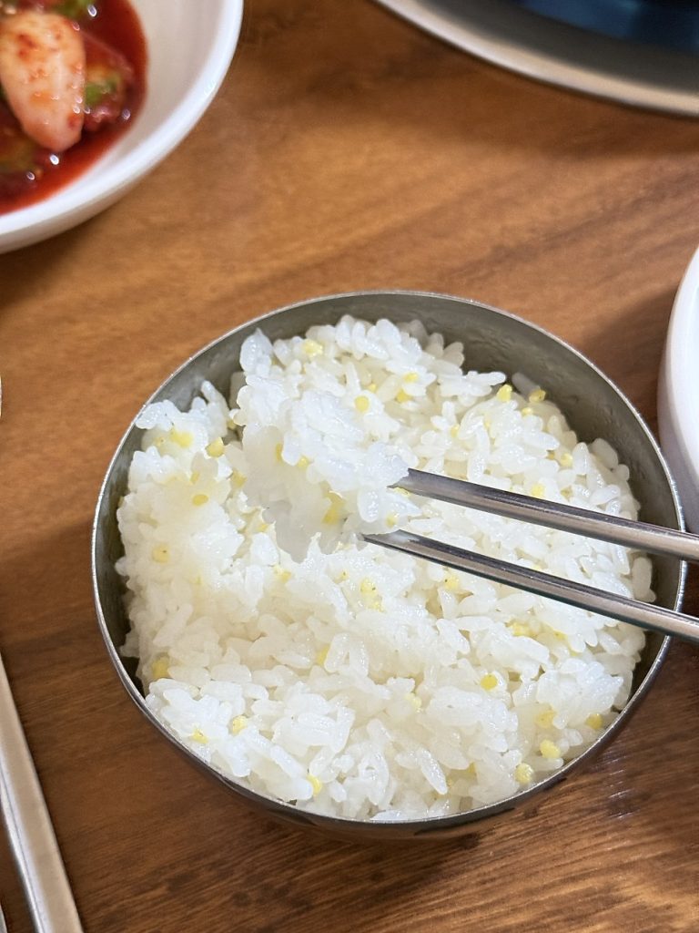 Spoonful of kimchi stew broth with bean rice