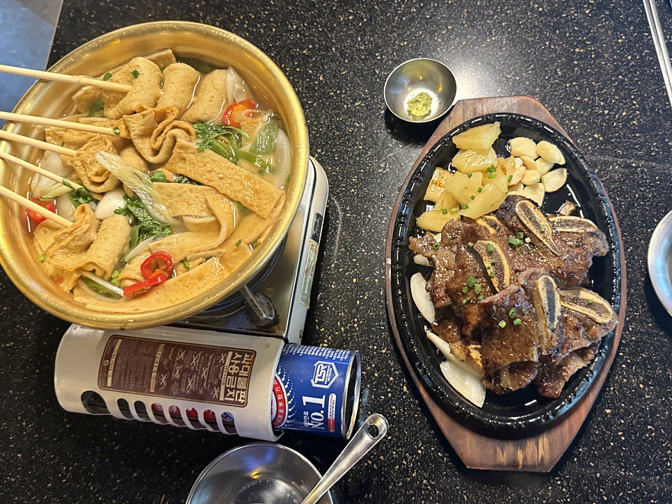 Table spread of galbi, fish cake soup and soju