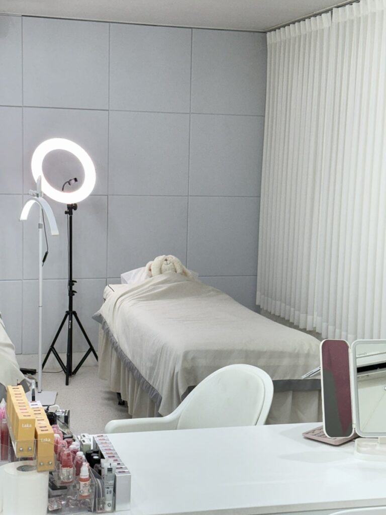 Treatment bed and a white work station by the curtains