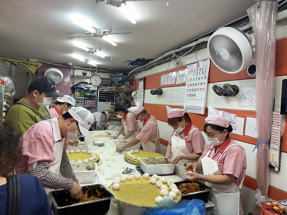 Staff folding dumplings by hand on the 1st floor