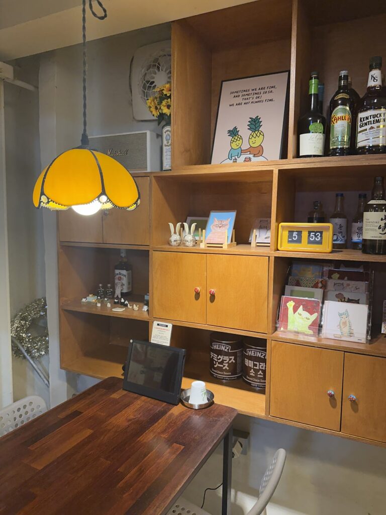 Cozy back table with wooden shelves and a yellow lamp