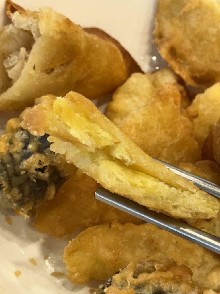 Fried seaweed roll cut open to show glass noodles inside