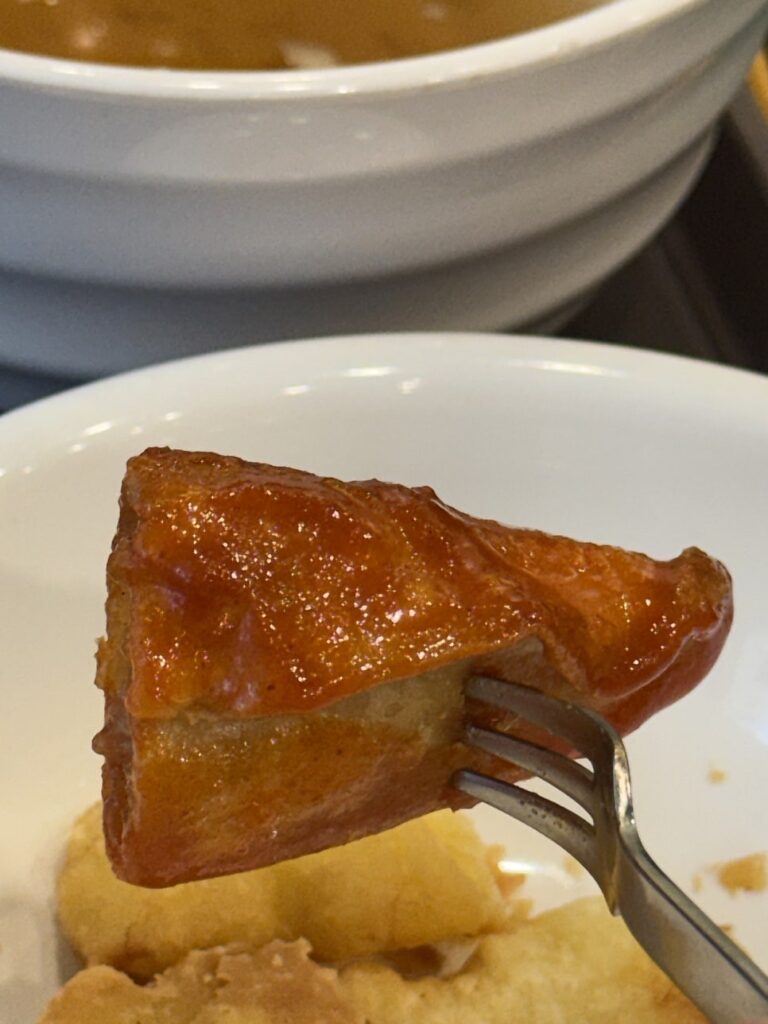 Fried snack dipped in tteokbokki sauce