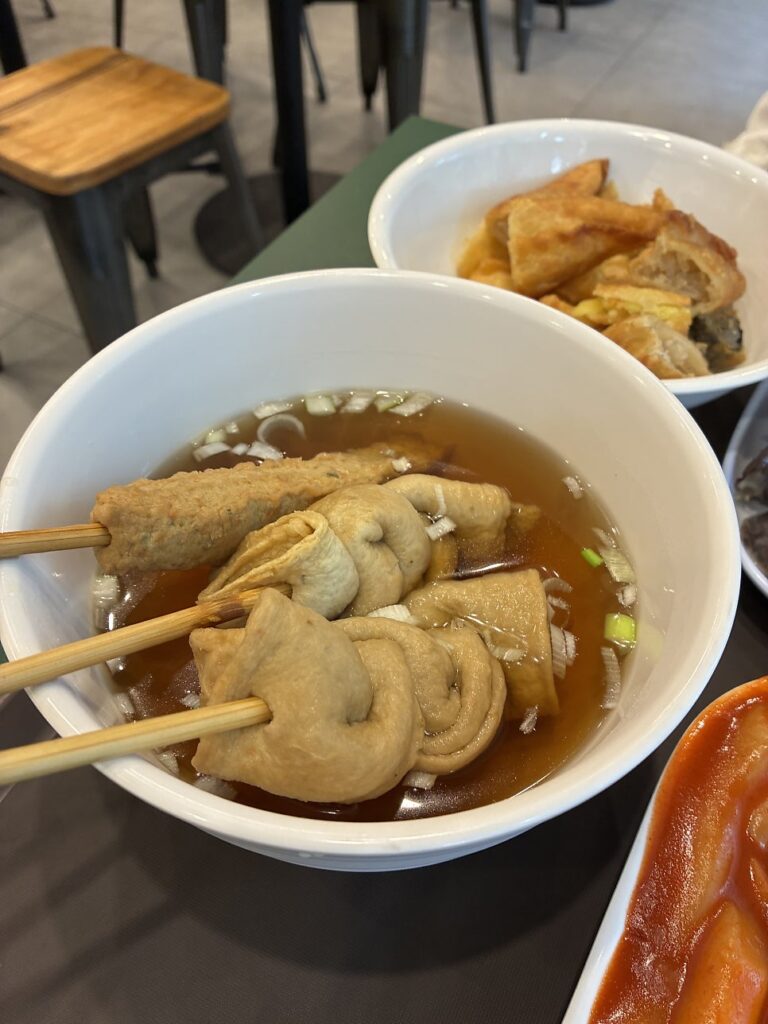 Fish cake skewers in clear broth
