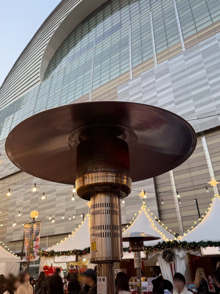 Tall patio heater warming the market area