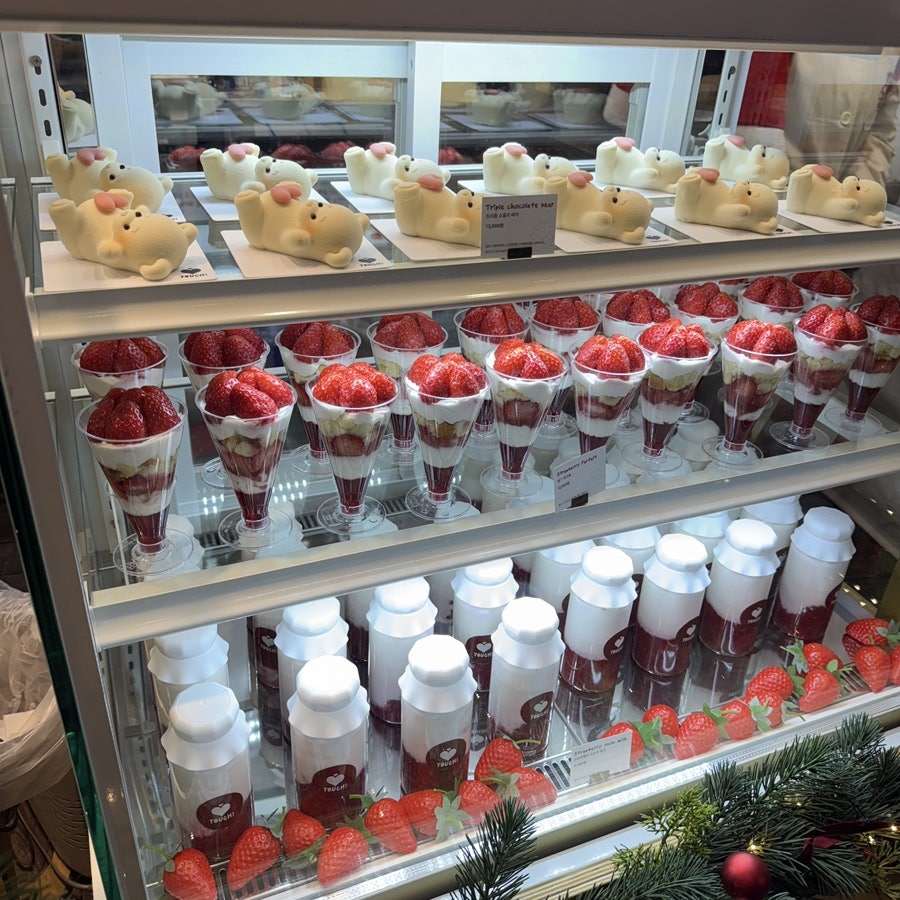 Strawberry parfaits and desserts in a market display case