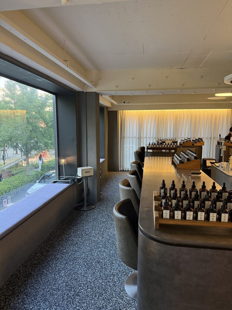 Long perfume blending bar beside big windows