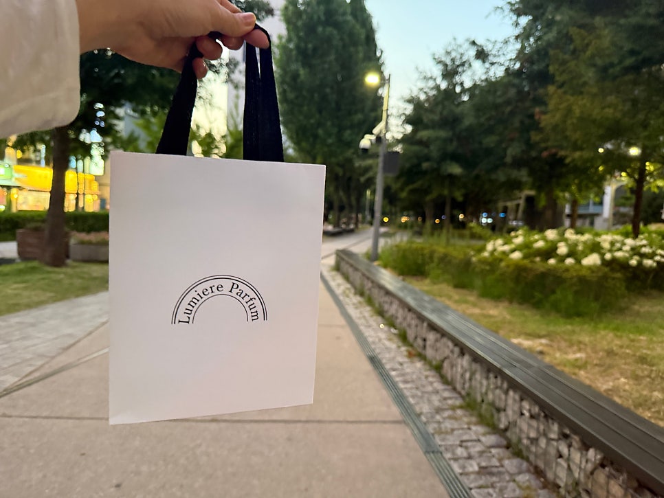 Lumiere Parfum shopping bag at the Gyeongui Line Forest Park at sunset