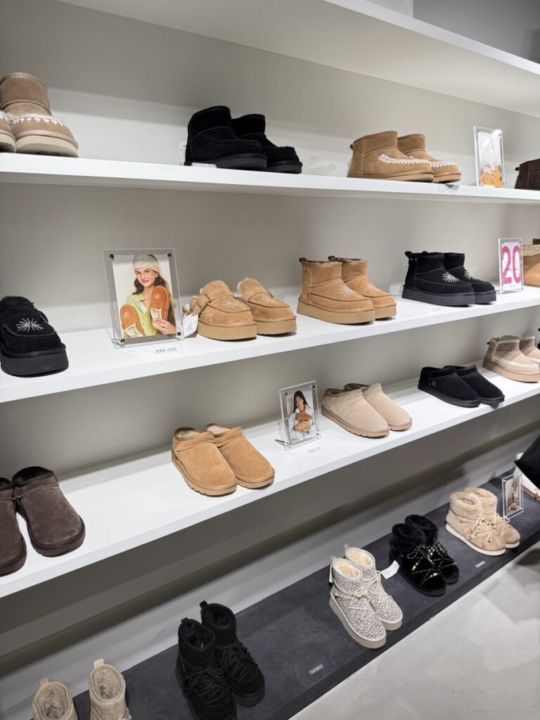 Shelves of fleece-lined boots and slippers in many colors