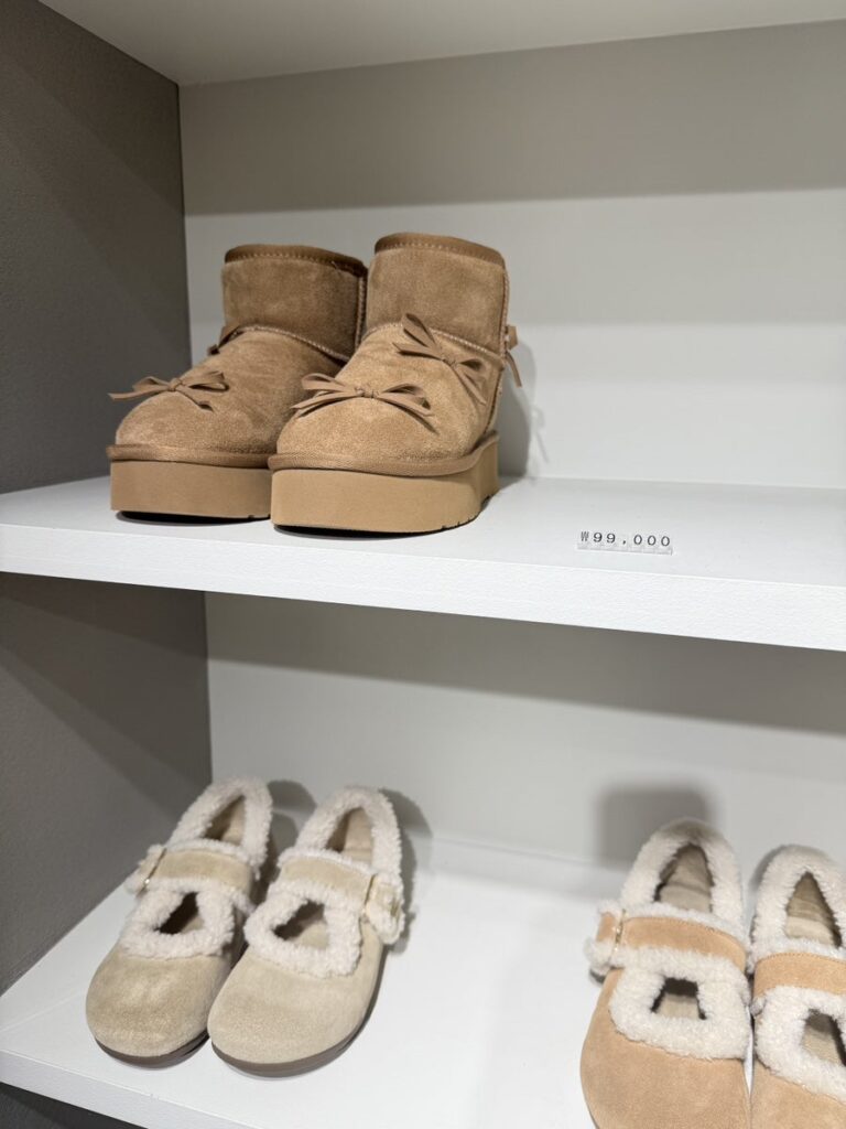 Suede ankle boots and fleece-trimmed Mary Janes on a shelf