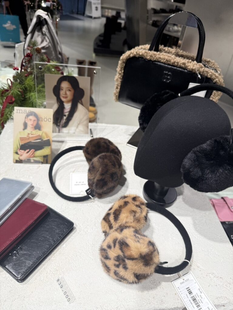 Fur earmuffs and winter bags on a display table