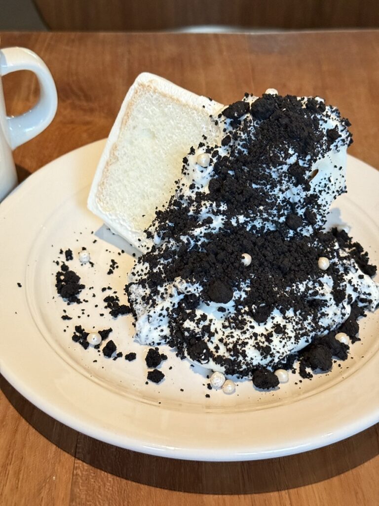 Tall slice of Oreo and cream cheese chiffon cake