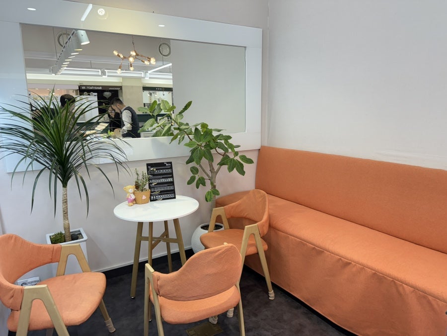 Bright orange sofa and chairs in the consultation corner