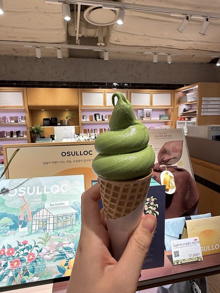 Osulloc matcha soft serve cone in front of the tea shop