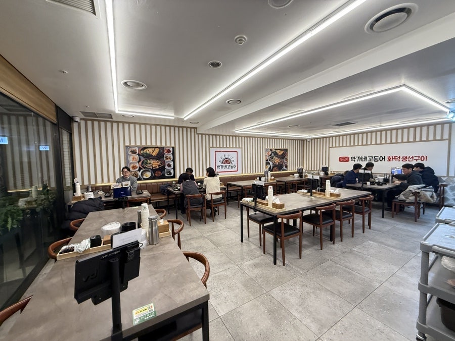 Spacious dining room with long wooden tables