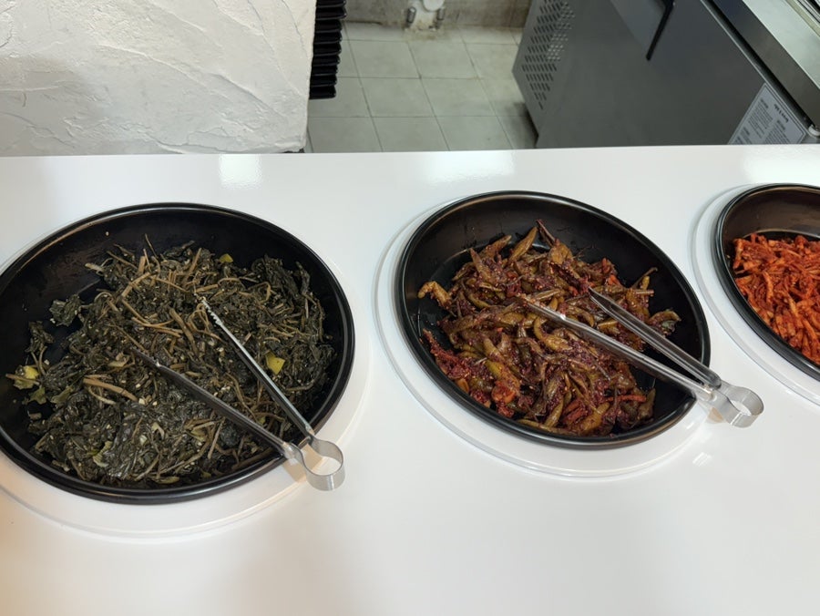 Seasoned vegetable side dishes at the self-serve bar