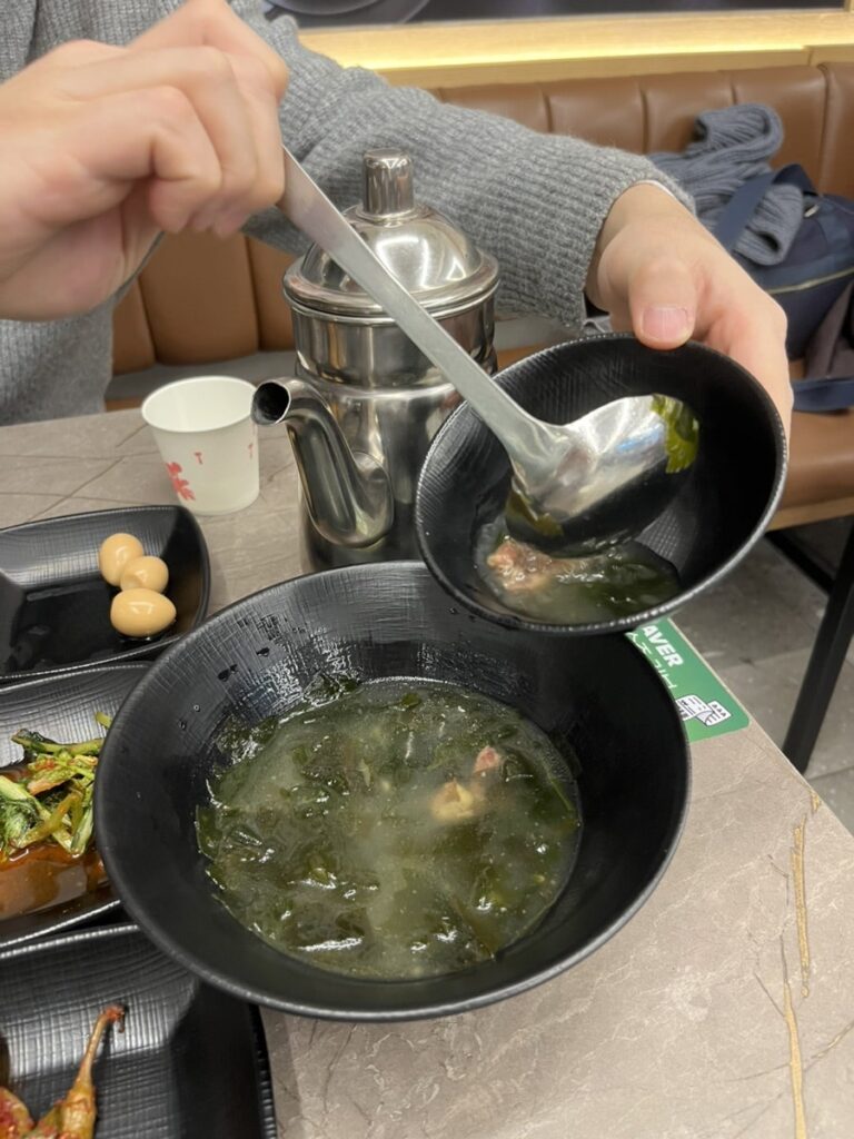 Bowl of seaweed soup being ladled at the table