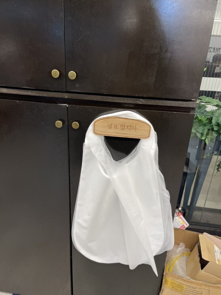 Aprons provided for diners, hanging on a hook