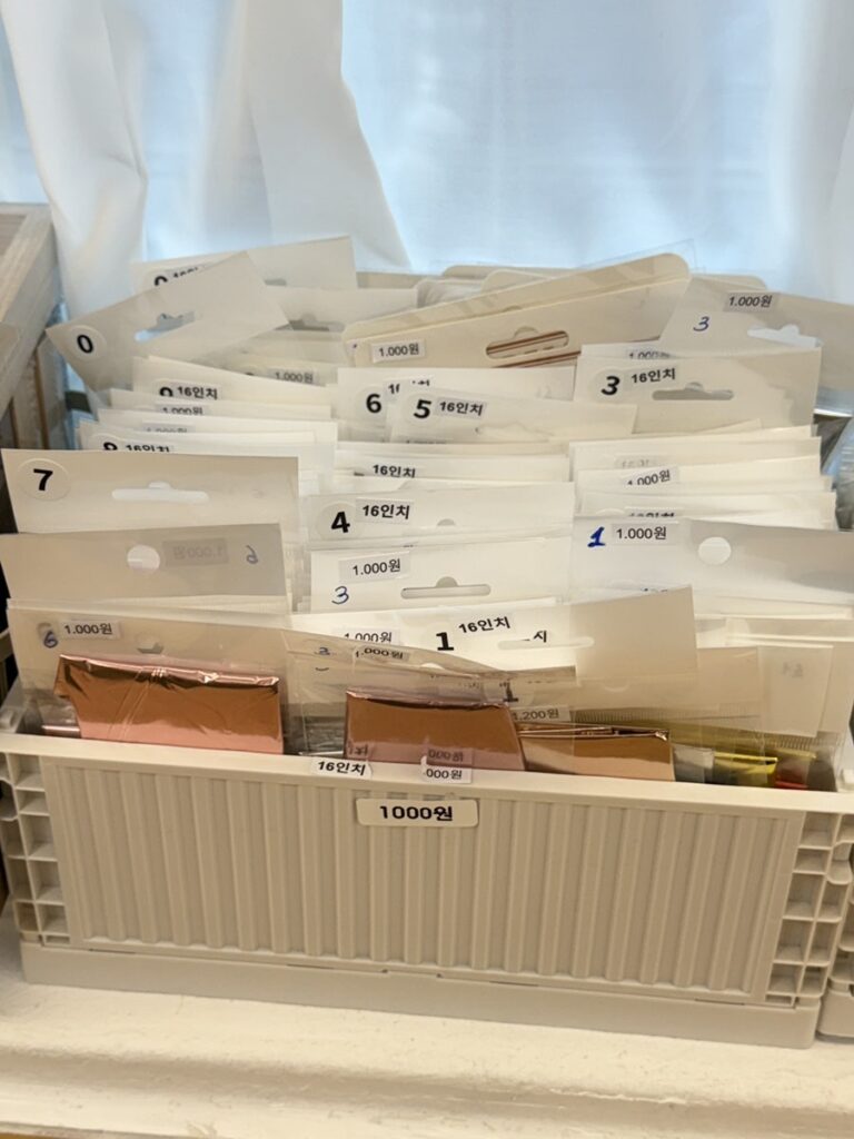 Box of small add-on prop packs labeled ₩1,000