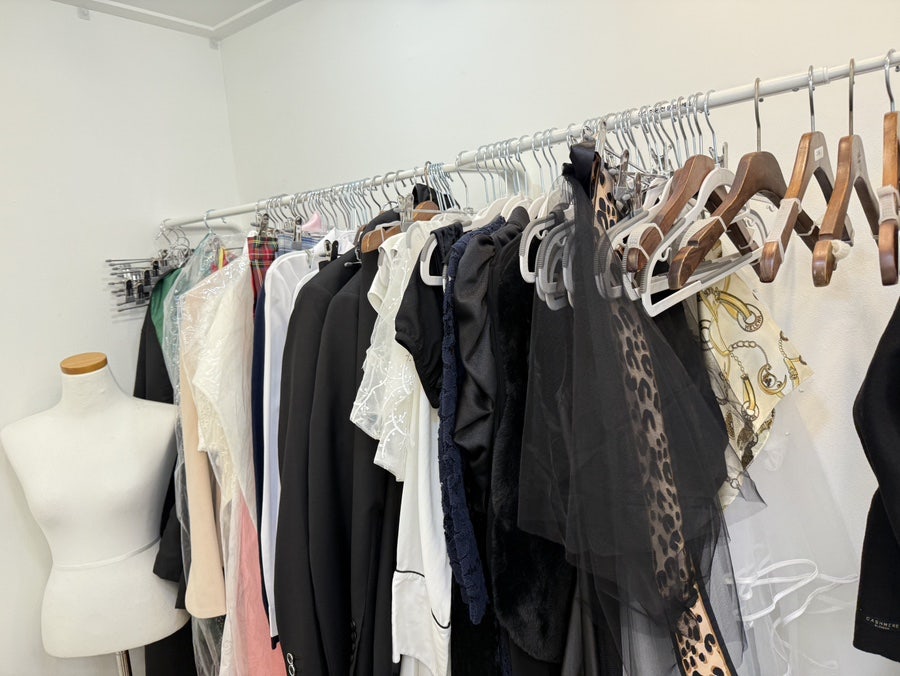 Rack of rental costumes and a dress form