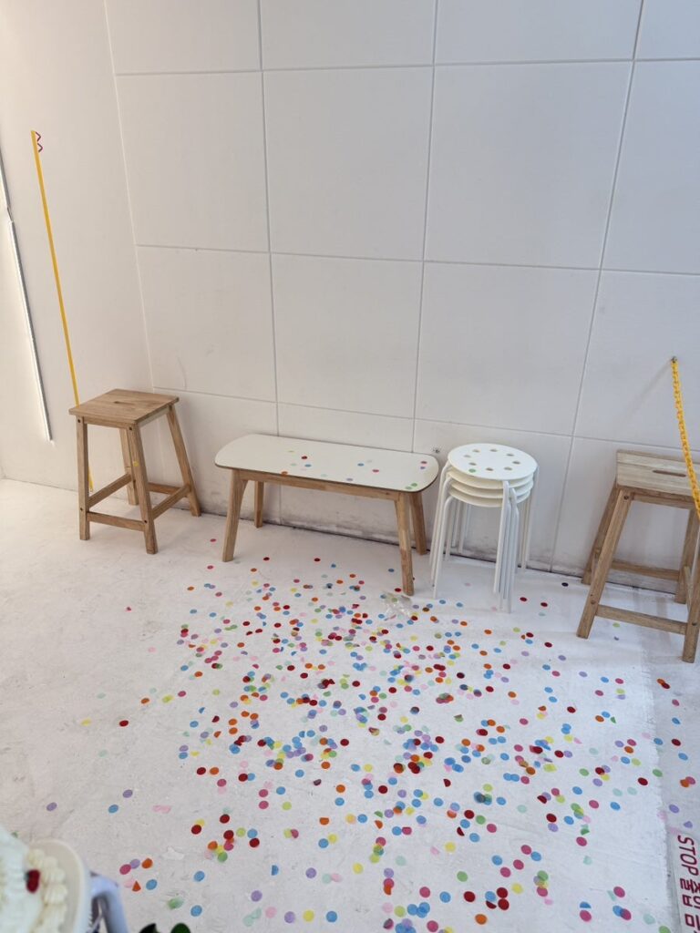 Studio set with wooden stools and confetti on the floor