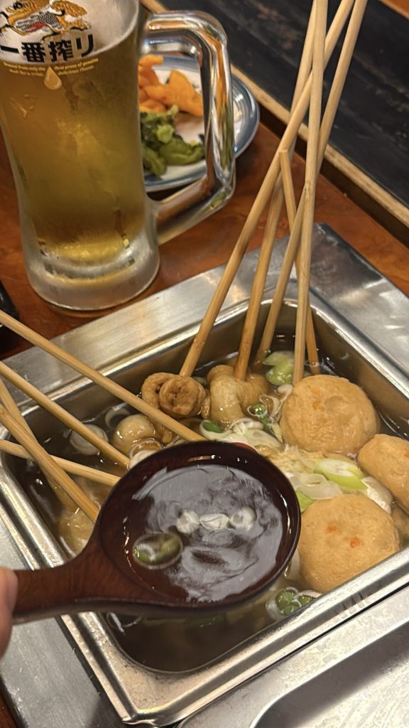 Clear oden broth in a ladle