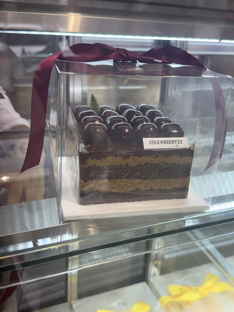 Chocolate cake with a burgundy ribbon at Strawberry32