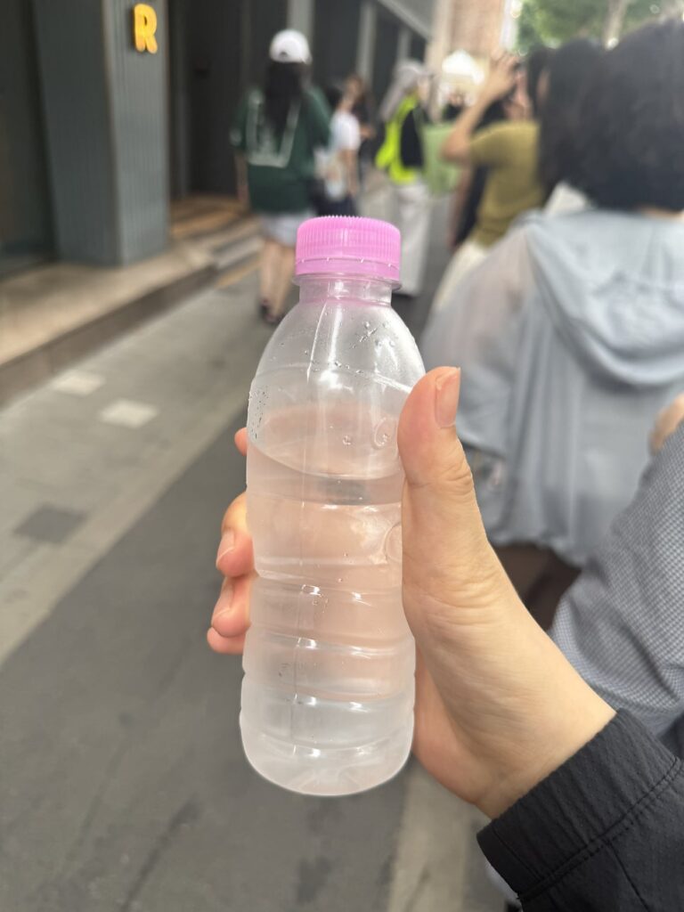 Free bottle of water handed out to people waiting in line