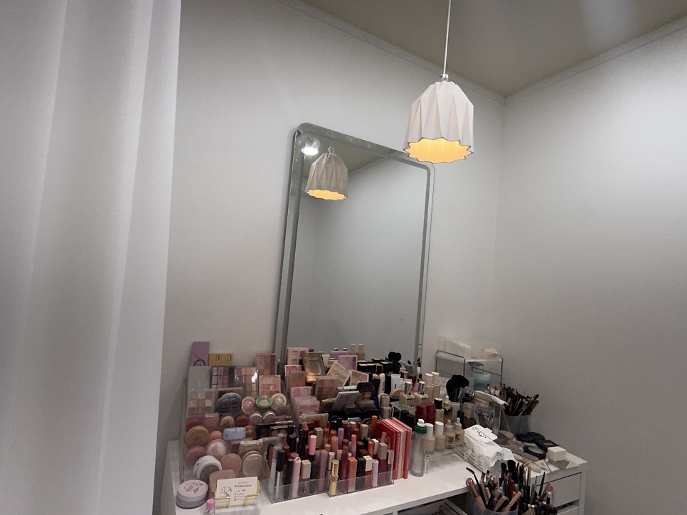 Makeup station with a big mirror and a pendant lamp