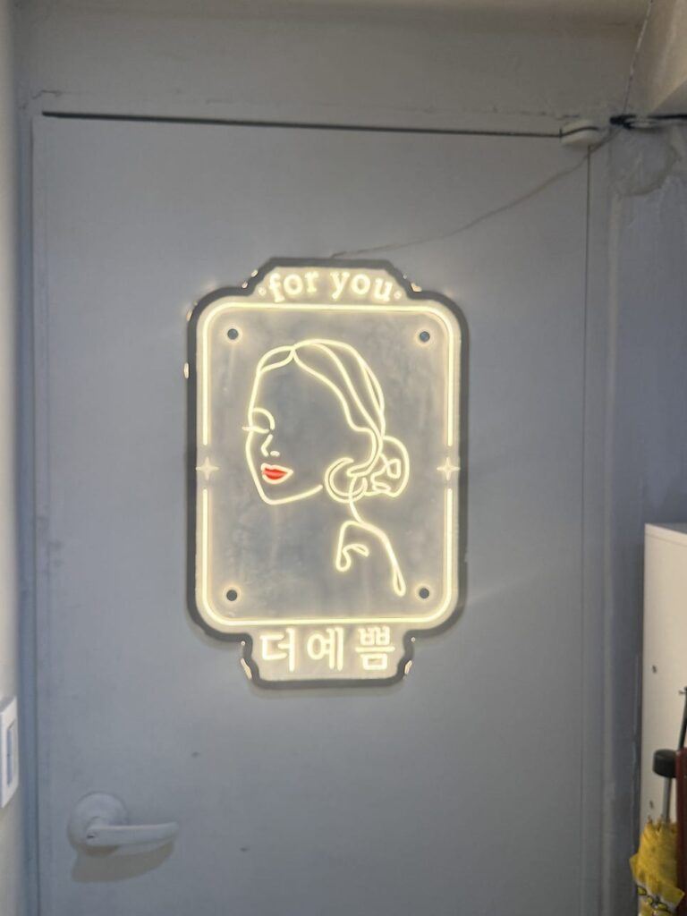 Neon "for you" sign at the salon entrance