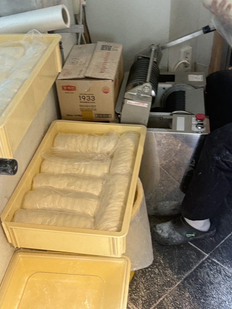 Trays of udon dough resting in the kitchen