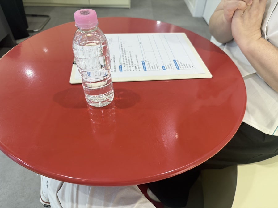 Consultation table with a form and bottled water