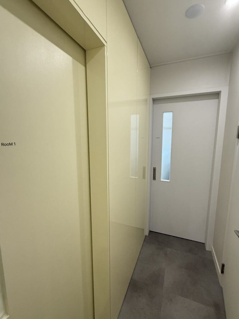 Warm yellow hallway leading to private rooms