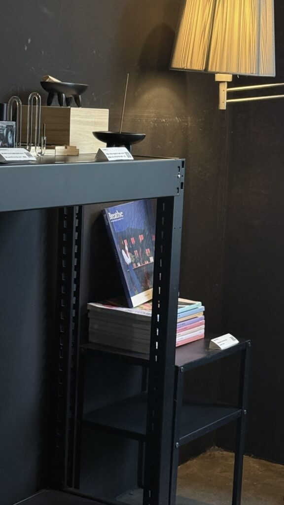 Dark, moody corner of Café Invited with a lamp and magazines