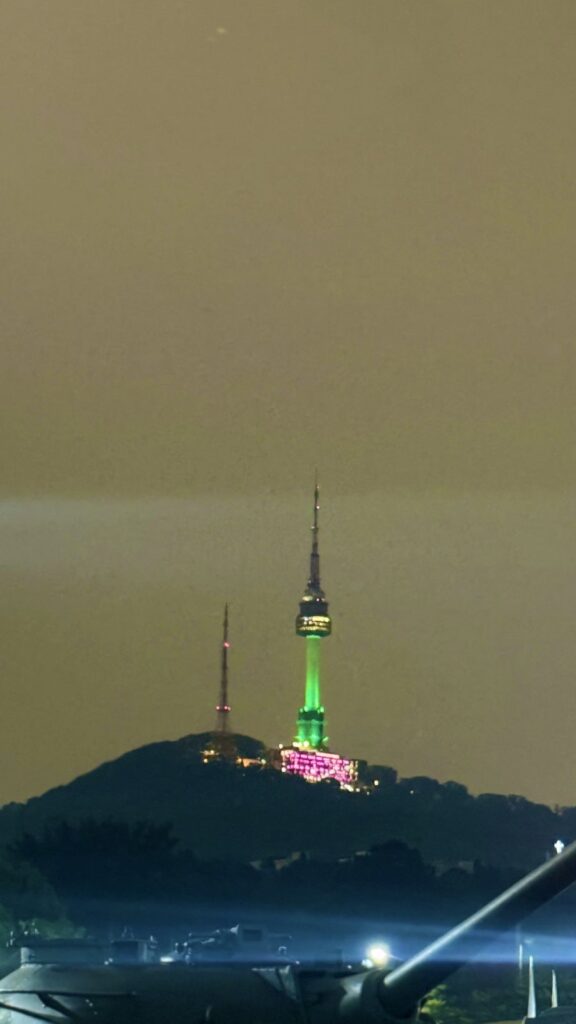 N Seoul Tower lit up on Namsan at night