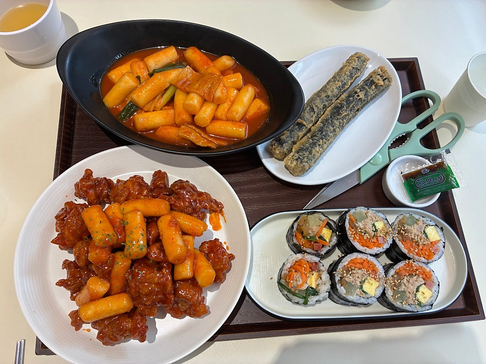 Full table of gimbap, chicken and tteokbokki